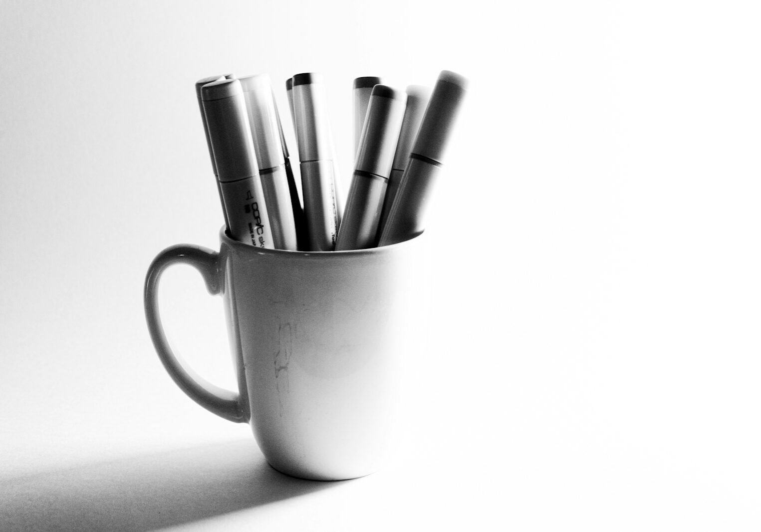 white ceramic mug with pen